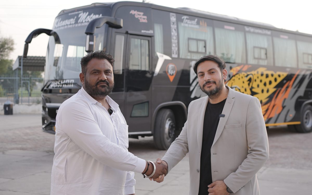 Handshake with Khanouri Motors in front of their cheetah-livery Spider coach